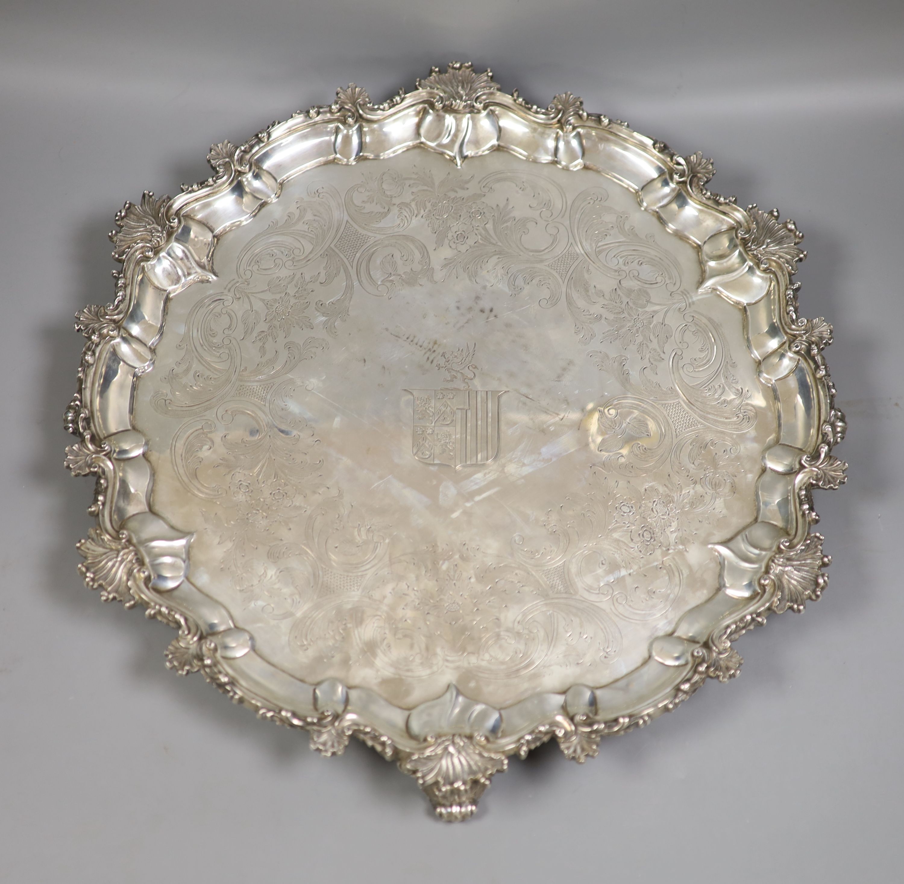 WITHDRAWN A George III large engraved silver salver, by Peter & William Bateman, London, 1809, with shell and scroll border, engraved armorial and later engraved inscription verso, (repair), diameter 46.3cm, 71oz.